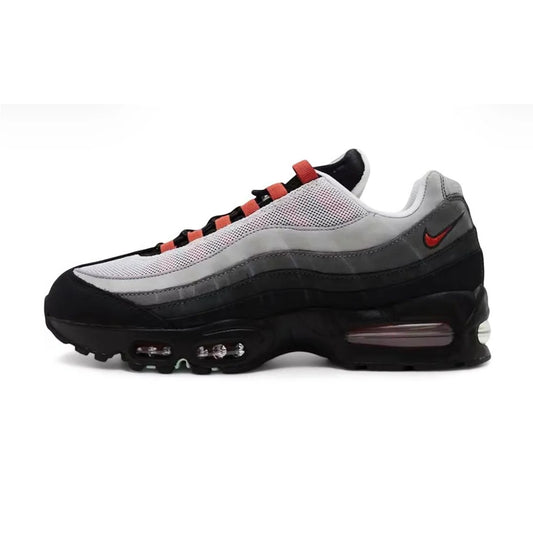 Lateral profile view of the Nike Air Max 95 Big Bubble Liverpool JD Sports Exclusive sneaker featuring a black midsole, graduated grey-to-black side panels, red lace loops, and a red heel Swoosh.