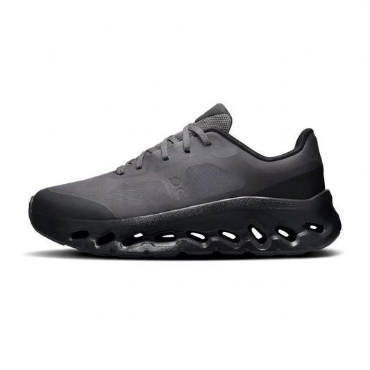 Lateral profile view of the On Running Cloudtilt Remix Black sneaker featuring a dark charcoal mesh upper, black On logo, and a fluid black CloudTec Phase midsole.