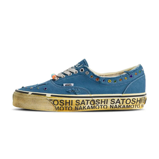 Three-quarter pair view of the Vans OTW Era 95 Satoshi Nakamoto Round Lucky Charm Navy shoes featuring distressed navy canvas, colorful stud embellishments, beaded lace accents, distressed toe cuts, and repeating Satoshi Nakamoto text around the aged midsole.