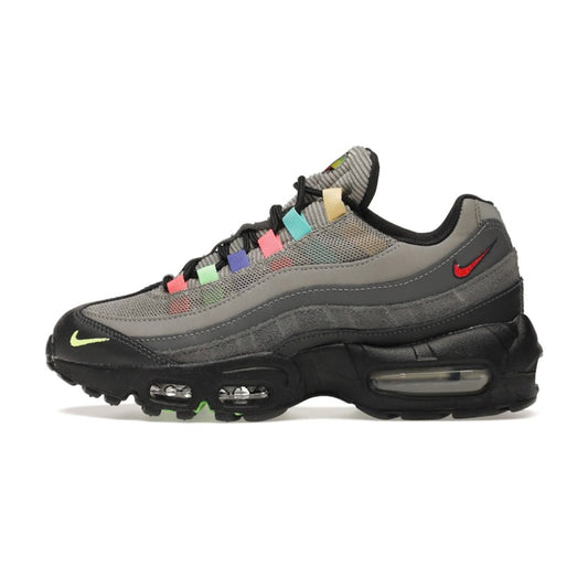 Side profile view of the Nike Air Max 95 SE Light Charcoal Vintage TV sneaker showing multi-color eyelets, grey gradient side panels, red rear mini Swoosh, and black visible Air midsole.
