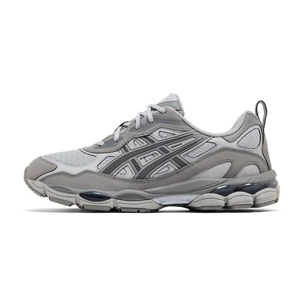 Lateral profile view of the ASICS GEL-NYC RGD Cement Grey sneaker featuring a tonal grey mesh and synthetic upper, grey midsole, dark charcoal GEL pods, and rugged construction.