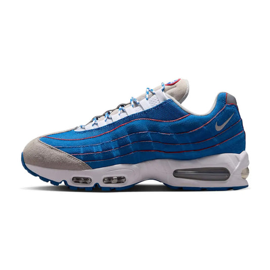 Lateral side view of the Nike Air Max 95 Big Bubble Lawson sneaker featuring royal blue side wave panels with red piping, a grey toe box and throat, white midsole with visible Big Bubble Air unit, and a blue rubber outsole.
