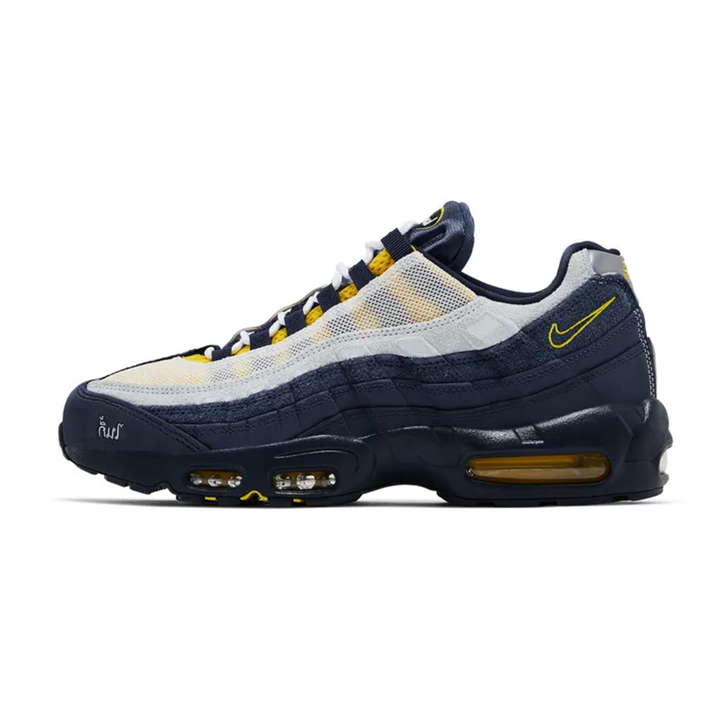 Lateral profile view of the Nike Air Max 95 SB Eric Koston Obsidian Speed Yellow sneaker featuring a dark obsidian and grey upper, translucent side mesh, speed yellow eyelets and heel Swoosh, and a black midsole with yellow Air units.