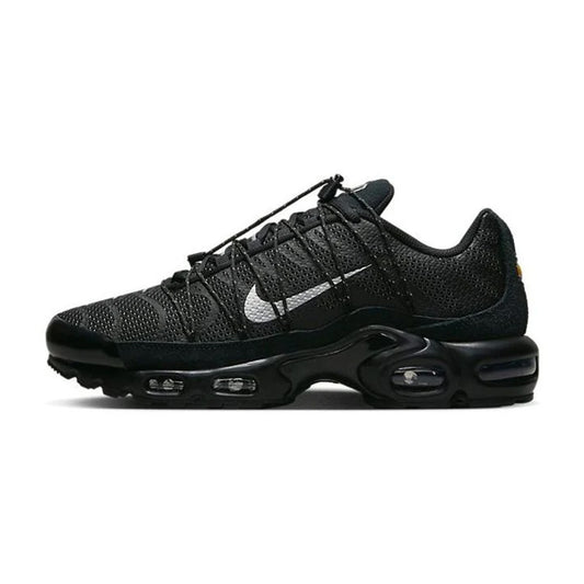 Lateral side view of the Nike Air Max Plus Toggle Black Reflective sneaker featuring a black mesh upper, toggle cord lacing, silver metallic Swoosh, black TPU wave overlays, and a black Tuned Air cushioned sole.