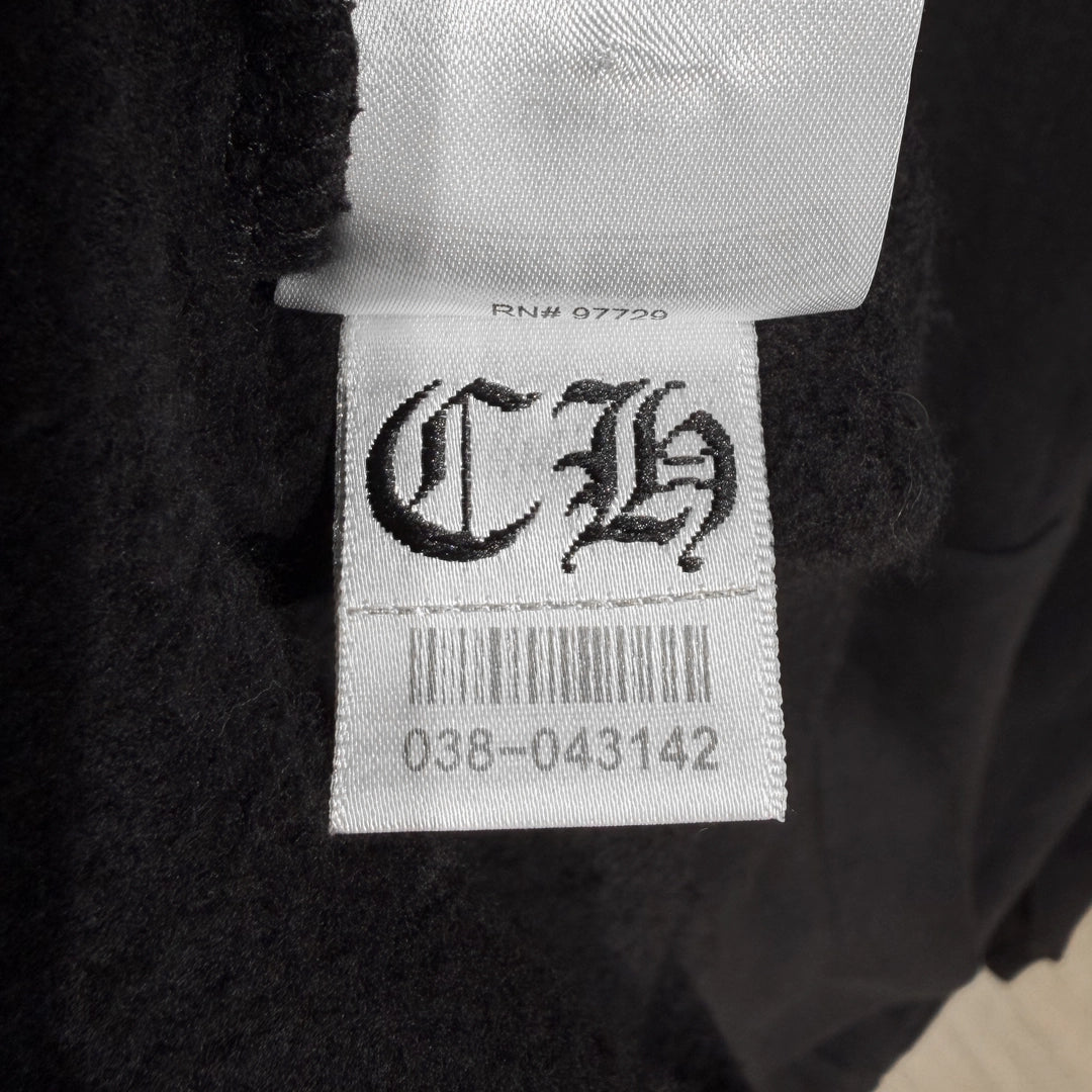 Close-up of the Chrome Hearts tag on the black Miami Exclusive Hoodie.