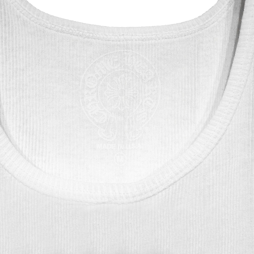 Close-up of the Chrome Hearts woven neck label on the white ribbed tank top.