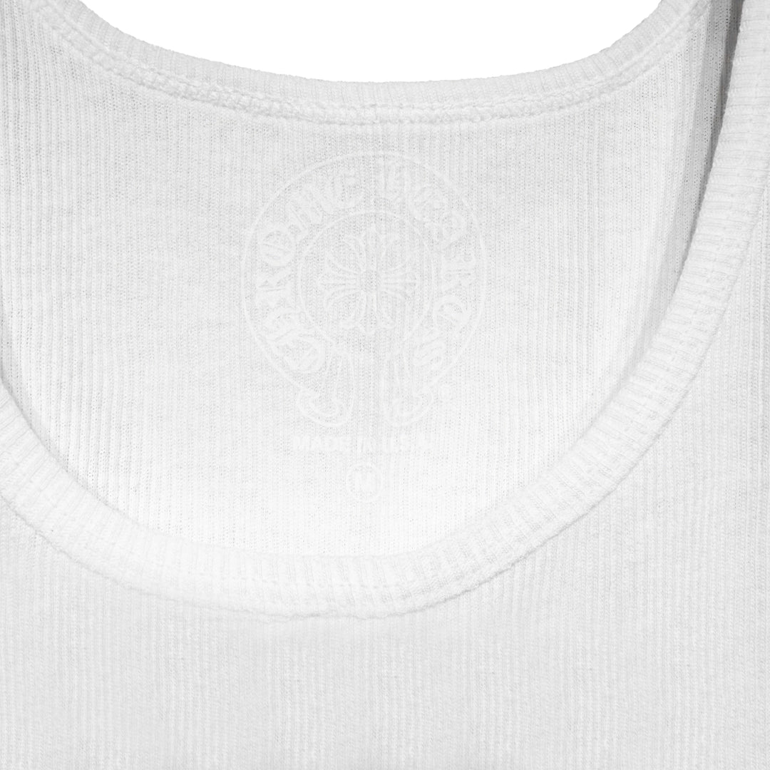 Close-up of the Chrome Hearts woven neck label on the white ribbed tank top.